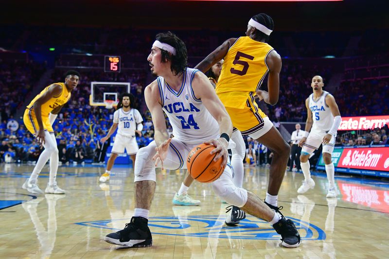 Mar 2, 2023; Los Angeles, California, USA; UCLA Bruins guard Jaime Jaquez Jr. (24) moves the ball ahead of Arizona State Sun Devils forward Jamiya Neal (5) during the second half at Pauley Pavilion. Mandatory Credit: Gary A. Vasquez-USA TODAY Sports