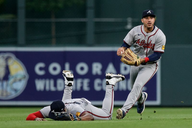 Aug 10, 2024; Denver, Colorado, USA; Atlanta Braves center fielder Ramon Laureano (18) fields the ball after right fielder Jorge Soler (2) was unable to make a catch in the third inning against the Colorado Rockies at Coors Field. Mandatory Credit: Isaiah J. Downing-USA TODAY Sports