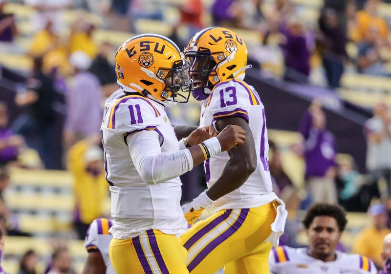 Oct 24, 2020; Baton Rouge, Louisiana, USA; LSU Tigers quarterback TJ Finley (11) celebrates with LSU Tigers wide receiver Jontre Kirklin (13) after a touchdown against the South Carolina Gamecocks during the first quarter at Tiger Stadium. Mandatory Credit: Derick E. Hingle-USA TODAY Sports