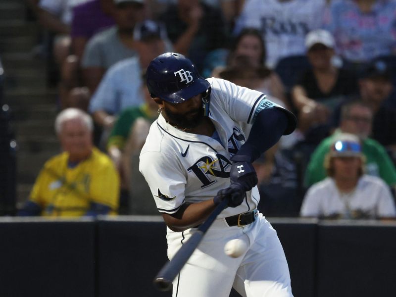 Jun 30, 2025; Tampa, Florida, USA;  Tampa Bay Rays third base Junior Caminero (13) hits a two-run home run against the Athletics during the fourth inning at George M. Steinbrenner Field. Mandatory Credit: Kim Klement Neitzel-Imagn Images