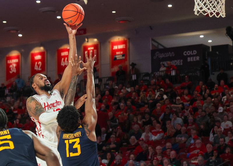 Jan 15, 2025; Houston, Texas, USA; Houston Cougars forward J'Wan Roberts (13) shoots against West Virginia Mountaineers forward Amani Hansberry (13)  in the second half at Fertitta Center. Mandatory Credit: Thomas Shea-Imagn Images