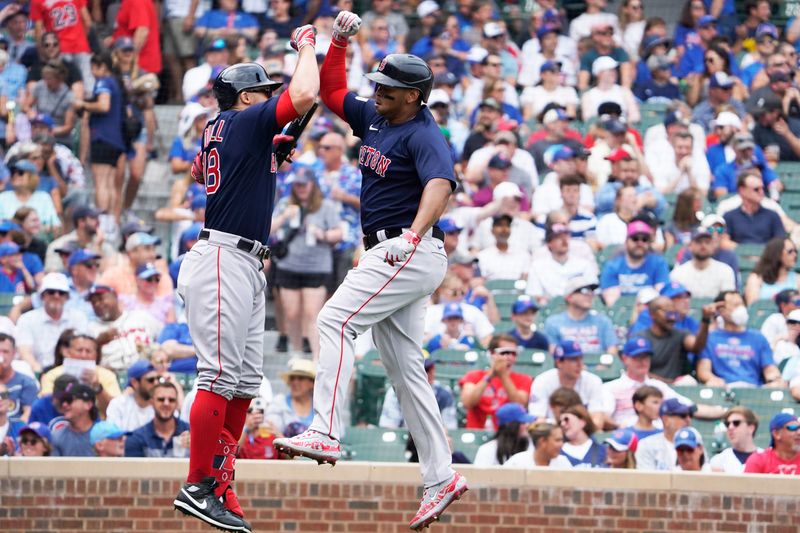 Jul 16, 2023; Chicago, Illinois, USA; Boston Red Sox third baseman Rafael Devers (11) celebrates his home run against the Chicago Cubs with Boston Red Sox right fielder Adam Duvall (18) during the first inning at Wrigley Field. Mandatory Credit: David Banks-USA TODAY Sports