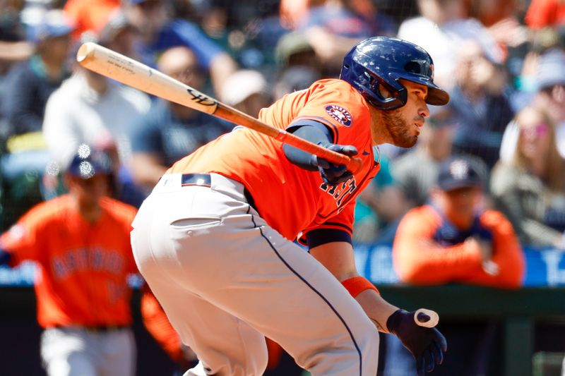 May 30, 2024; Seattle, Washington, USA; Houston Astros catcher Victor Caratini (17) hits an RBI-fielders choice against the Seattle Mariners during the sixth inning at T-Mobile Park. Mandatory Credit: Joe Nicholson-USA TODAY Sports