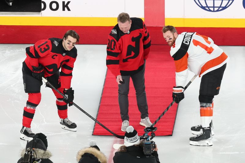 Feb 17, 2024; East Rutherford, New Jersey, USA; New Jersey Devils center Nico Hischier (13) and Philadelphia Flyers center Sean Couturier (14) pose for a photo of the puck drop from retired NHL player Martin Brodeur in a Stadium Series ice hockey game at MetLife Stadium. Mandatory Credit: Vincent Carchietta-USA TODAY Sports