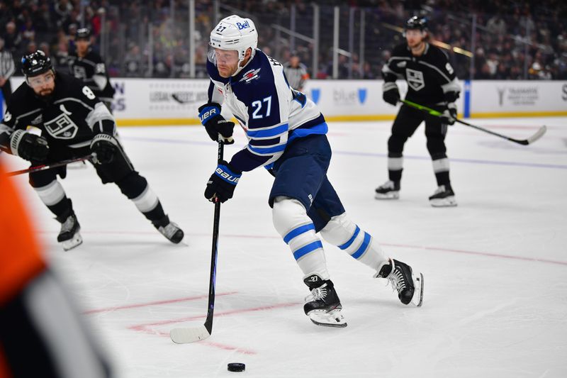 Dec 13, 2023; Los Angeles, California, USA; Winnipeg Jets left wing Nikolaj Ehlers (27) moves the puck against the Los Angeles Kings during the first period at Crypto.com Arena. Mandatory Credit: Gary A. Vasquez-USA TODAY Sports