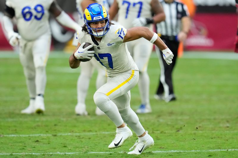 Los Angeles Rams wide receiver Puka Nacua runs with the ball against the Arizona Cardinals during the second half of an NFL football game Sunday, Nov. 26, 2023, in Glendale, Ariz. The Rams won 37-14. (AP Photo/Ross D. Franklin)