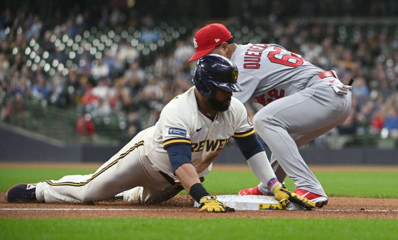 Sep 28, 2023; Milwaukee, Wisconsin, USA; Milwaukee Brewers first baseman Carlos Santana (41) slides in safely to third base ahead of the tag by St. Louis Cardinals third baseman Juniel Querecuto (62) at American Family Field. Mandatory Credit: Michael McLoone-USA TODAY Sports