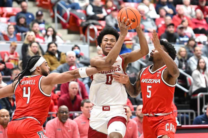 Jan 13, 2024; Pullman, Washington, USA; Washington State Cougars forward Jaylen Wells (0) shoots the ball against Arizona Wildcats guards KJ Lewis (5) and Kylan Boswell (4) in the first half at Friel Court at Beasley Coliseum. Mandatory Credit: James Snook-USA TODAY Sports