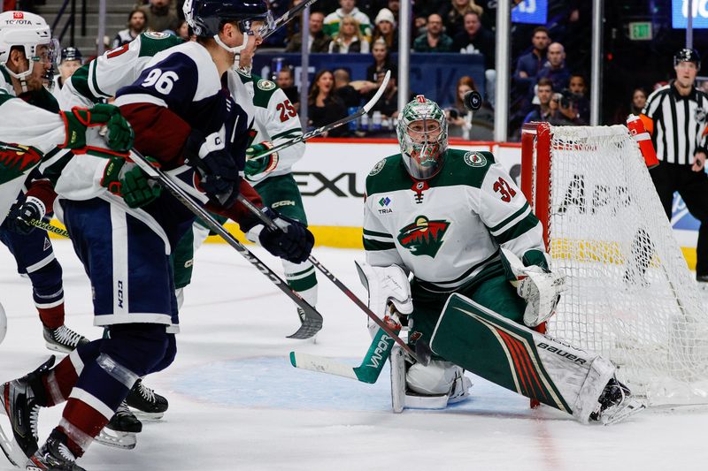 Mar 8, 2024; Denver, Colorado, USA; Minnesota Wild goaltender Filip Gustavsson (32) watches the puck as Colorado Avalanche right wing Mikko Rantanen (96) defends in the second period at Ball Arena. Mandatory Credit: Isaiah J. Downing-USA TODAY Sports