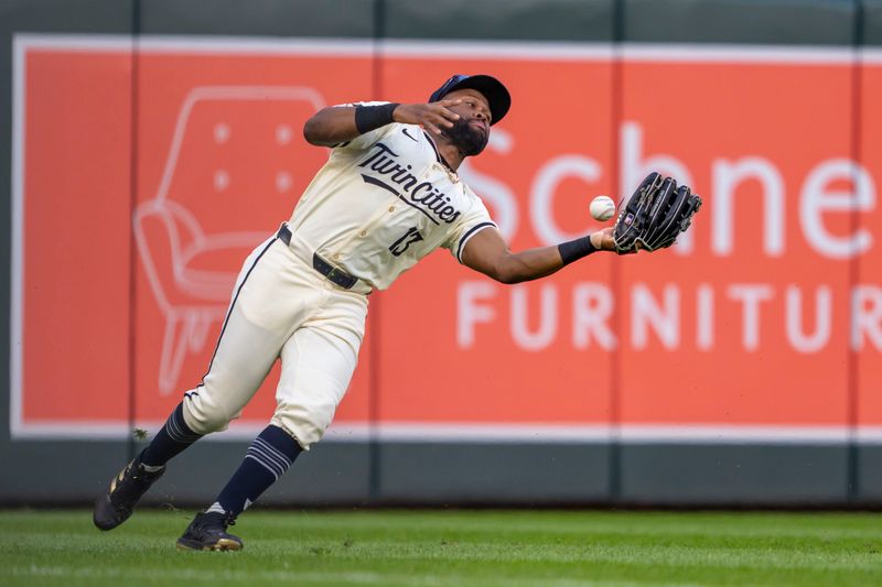 Jun 11, 2024; Minneapolis, Minnesota, USA; Minnesota Twins left fielder Manuel Margot (13) attempts to catch a fly ball against the Colorado Rockies in the fifth inning at Target Field. Mandatory Credit: Jesse Johnson-USA TODAY Sports