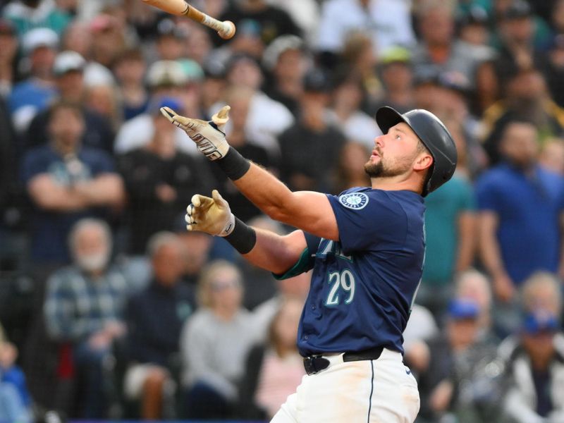 Jun 10, 2024; Seattle, Washington, USA; Seattle Mariners catcher Cal Raleigh (29) catches his bat after losing his grip while swinging at a pitch during the eighth inning against the Chicago White Sox at T-Mobile Park. Mandatory Credit: Steven Bisig-USA TODAY Sports