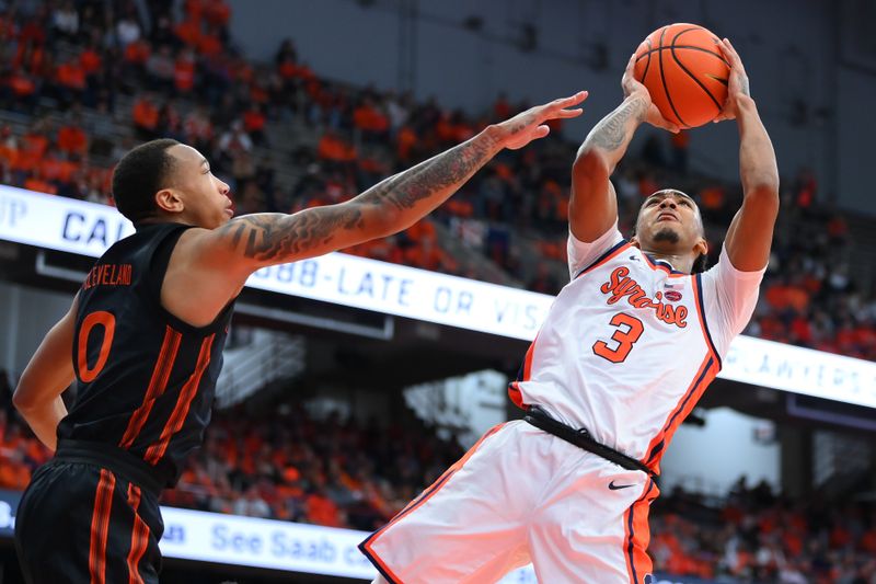 Jan 20, 2024; Syracuse, New York, USA; Syracuse Orange guard Judah Mintz (3) shoots the ball as Miami (Fl) Hurricanes guard Matthew Cleveland (0) defends during the second half at the JMA Wireless Dome. Mandatory Credit: Rich Barnes-USA TODAY Sports