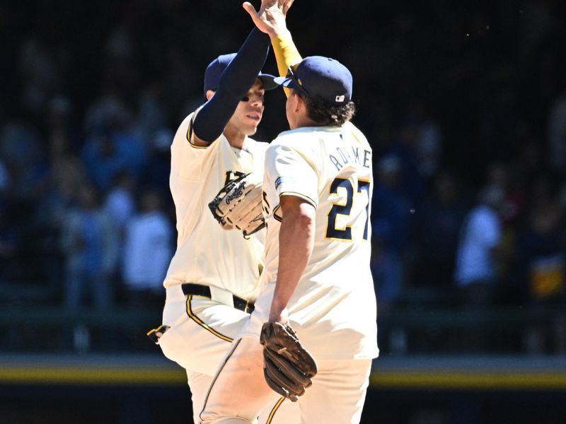 May 30, 2024; Milwaukee, Wisconsin, USA; Milwaukee Brewers outfielder Christian Yelich (22) and shortstop Willy Adames (27) celebrate a win over the Chicago Cubs at American Family Field. Mandatory Credit: Michael McLoone-USA TODAY Sports