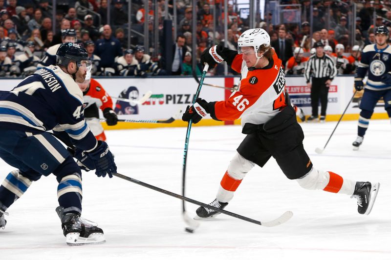 Jan 28, 2026; Columbus, Ohio, USA;Philadelphia Flyers center Trevor Zegras (46) wrists a shot on goal as Columbus Blue Jackets defenseman Erik Gudbranson (44) defends during the first period at Nationwide Arena. Mandatory Credit: Russell LaBounty-Imagn Images