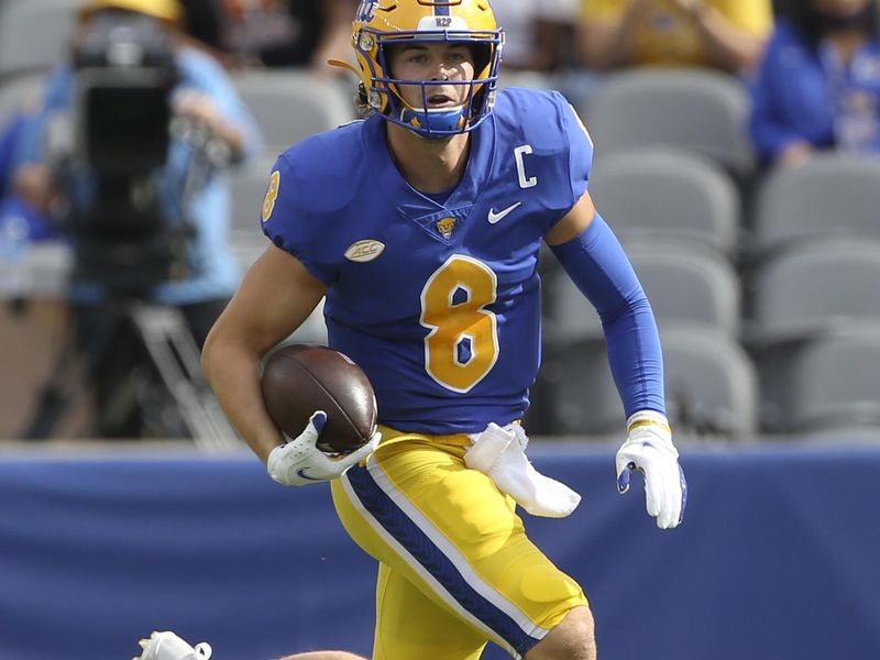 Sep 4, 2021; Pittsburgh, Pennsylvania, USA;  Pittsburgh Panthers quarterback Kenny Pickett (8) caries the ball against the Massachusetts Minutemen during the first quarter at Heinz Field. Mandatory Credit: Charles LeClaire-USA TODAY Sports