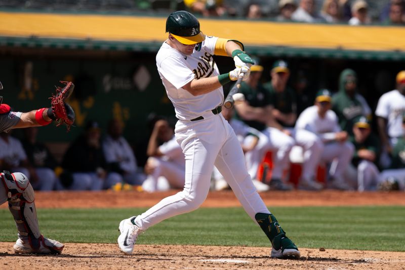 Apr 17, 2024; Oakland, California, USA; Oakland Athletics right fielder Tyler Nevin (26) connects for an RBI single against the St. Louis Cardinals during the sixth inning at Oakland-Alameda County Coliseum. Mandatory Credit: D. Ross Cameron-USA TODAY Sports