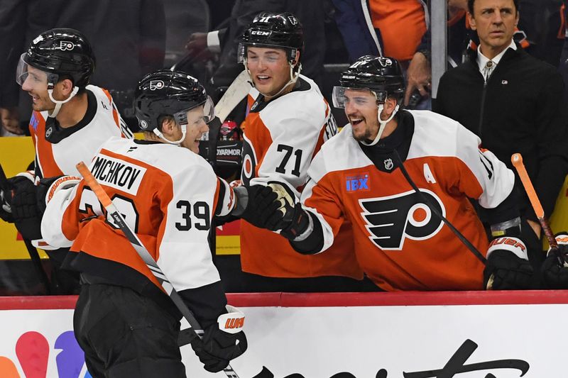 Sep 26, 2024; Philadelphia, Pennsylvania, USA; Philadelphia Flyers right wing Matvei Michkov (39) celebrates his goal with right wing Tyson Foerster (71) and right wing Travis Konecny (11) against the New York Islanders during the third period at Wells Fargo Center. Mandatory Credit: Eric Hartline-Imagn Images