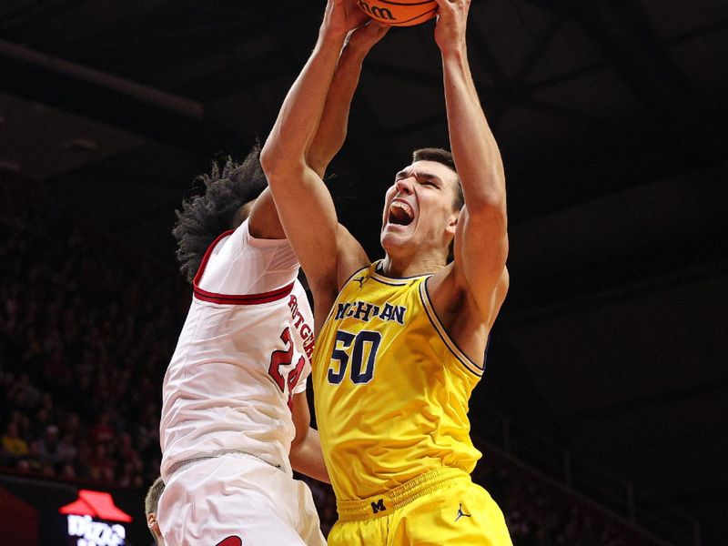 Feb 1, 2025; Piscataway, New Jersey, USA; Michigan Wolverines center Vladislav Goldin (50) rebounds against Rutgers Scarlet Knights center Lathan Sommerville (24) during the second half at Jersey Mike's Arena. Mandatory Credit: Vincent Carchietta-Imagn Images