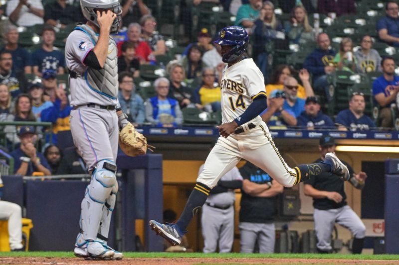 Sep 12, 2023; Milwaukee, Wisconsin, USA; Milwaukee Brewers third baseman Andruw Monasterio (14) scores on a sacrifice fly in the seventh inning against the Miami Marlins at American Family Field. Mandatory Credit: Benny Sieu-USA TODAY Sports