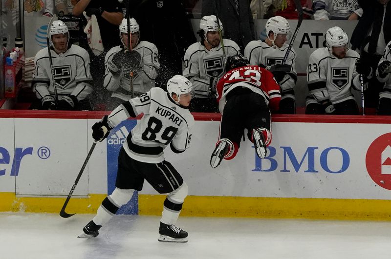 Jan 22, 2023; Chicago, Illinois, USA; Los Angeles Kings center Rasmus Kupari (89) checks Chicago Blackhawks center Colin Blackwell (43) into the Kings bench during the third period at United Center. Mandatory Credit: David Banks-USA TODAY Sports