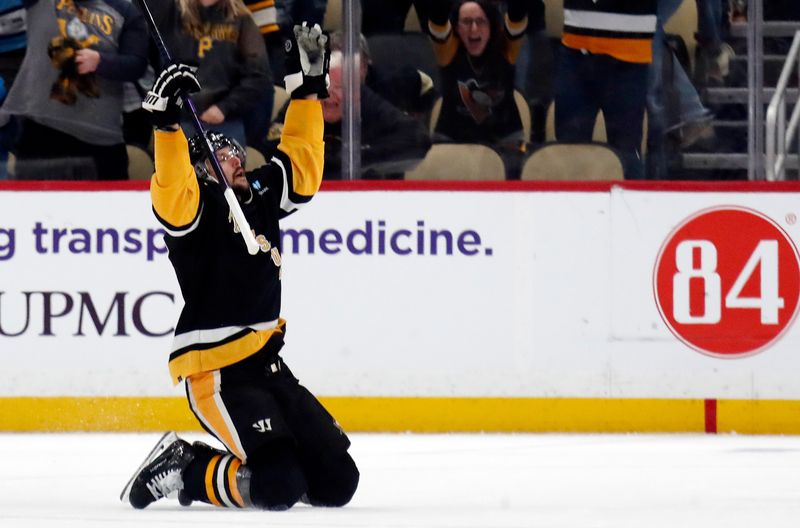Apr 11, 2024; Pittsburgh, Pennsylvania, USA; Pittsburgh Penguins defenseman Erik Karlsson (65) reacts after scoring the game winning goal against the Detroit Red Wings in overtime at PPG Paints Arena. Pittsburgh won 6-5 in overtime. Mandatory Credit: Charles LeClaire-USA TODAY Sports