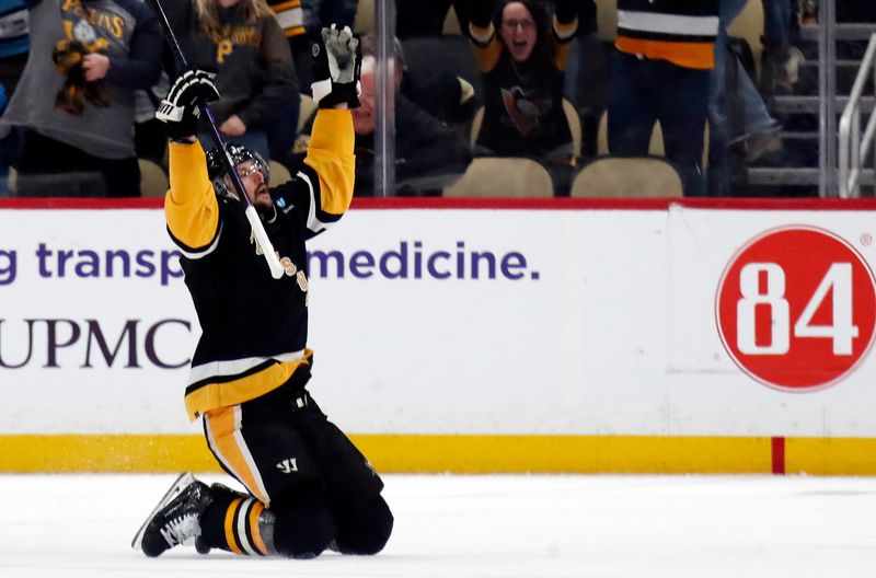 Apr 11, 2024; Pittsburgh, Pennsylvania, USA; Pittsburgh Penguins defenseman Erik Karlsson (65) reacts after scoring the game winning goal against the Detroit Red Wings in overtime at PPG Paints Arena. Pittsburgh won 6-5 in overtime. Mandatory Credit: Charles LeClaire-USA TODAY Sports