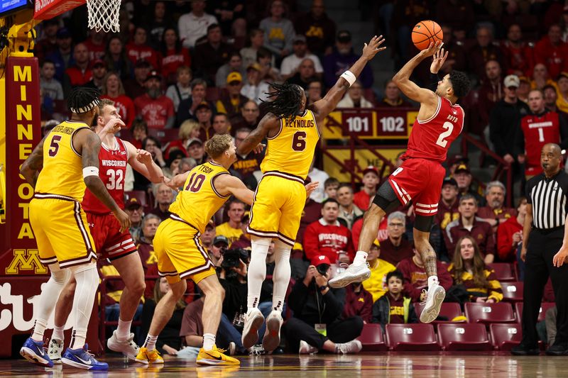 Jan 13, 2026; Minneapolis, Minnesota, USA; Wisconsin Badgers guard Nick Boyd (2) shoots over Minnesota Golden Gophers guard Langston Reynolds (6) during the first half at Williams Arena. Mandatory Credit: Matt Krohn-Imagn Images