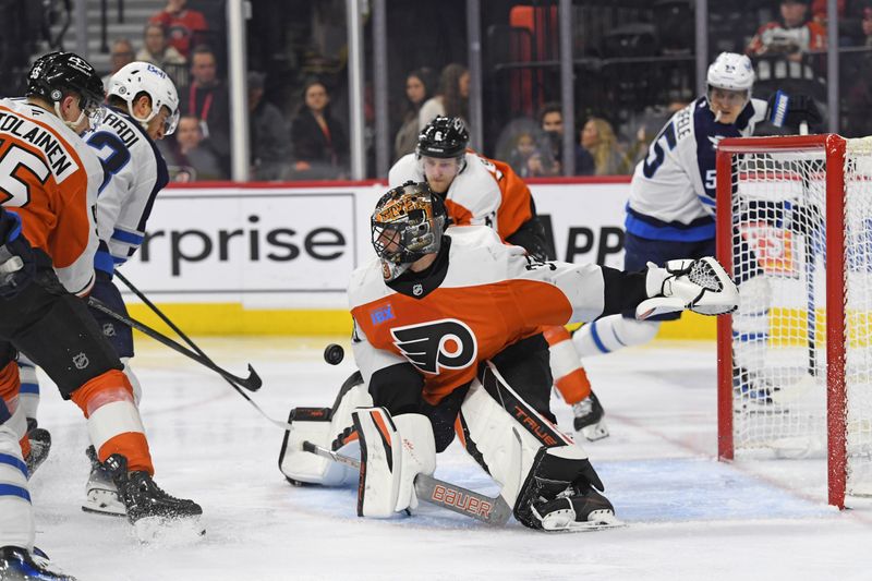 Mar 6, 2025; Philadelphia, Pennsylvania, USA; Philadelphia Flyers goaltender Samuel Ersson (33) makes a save against Winnipeg Jets center Gabriel Vilardi (13) during the second period at Wells Fargo Center. Mandatory Credit: Eric Hartline-Imagn Images