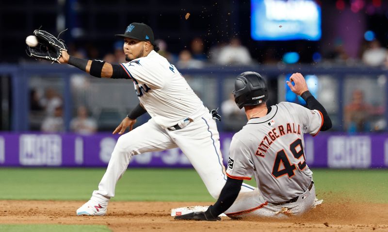 Apr 16, 2024; Miami, Florida, USA;  San Francisco Giants shortstop Tyler Fitzgerald (49) steals second base against Miami Marlins second baseman Luis Arraez (3) in the fifth inning at loanDepot Park. Mandatory Credit: Rhona Wise-USA TODAY Sports