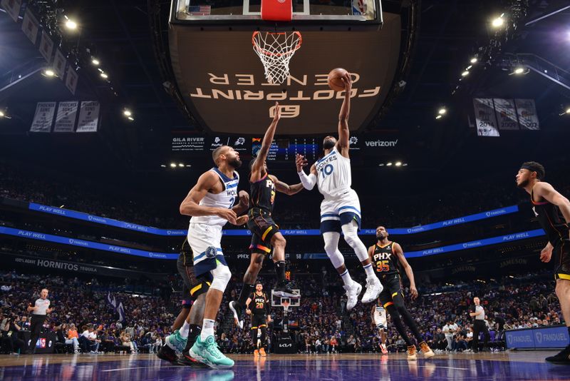 PHOENIX, AZ - APRIL 4: Mike Conley #10 of the Minnesota Timberwolves drives to the basket during the game against the Phoenix Suns during Round 1 Game 4 of the 2024 NBA Playoffs on April 4, 2023 at Footprint Center in Phoenix, Arizona. NOTE TO USER: User expressly acknowledges and agrees that, by downloading and or using this photograph, user is consenting to the terms and conditions of the Getty Images License Agreement. Mandatory Copyright Notice: Copyright 2024 NBAE (Photo by Barry Gossage/NBAE via Getty Images)