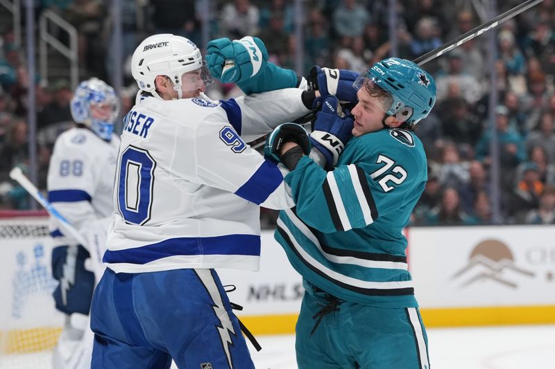 Jan 3, 2026; San Jose, California, USA; Tampa Bay Lightning defenseman J.J. Moser (left) and San Jose Sharks left wing William Eklund (72) fight during the second period at SAP Center at San Jose. Mandatory Credit: Darren Yamashita-Imagn Images
