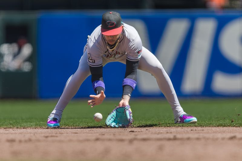 Apr 21, 2024; San Francisco, California, USA;  Arizona Diamondbacks first baseman Pavin Smith (26) fields a round ball for an out against the San Francisco Giants during the second inning at Oracle Park. Mandatory Credit: John Hefti-USA TODAY Sports