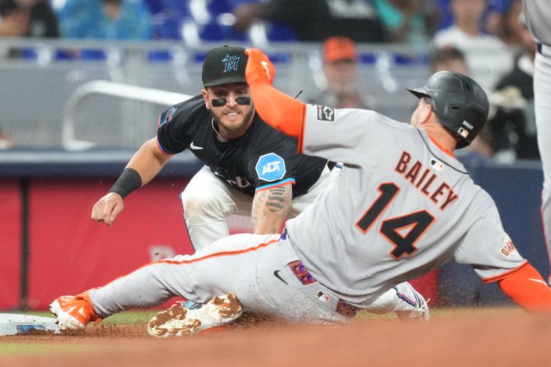 May 30, 2025; Miami, Florida, USA;  Miami Marlins third baseman Connor Norby (1) tags out San Francisco Giants catcher Patrick Bailey (14) in the second inning at loanDepot Park. Mandatory Credit: Jim Rassol-Imagn Images