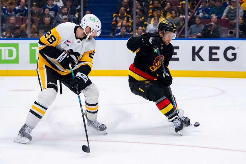 Oct 26, 2024; Vancouver, British Columbia, CAN; Pittsburgh Penguins defenseman Marcus Pettersson (28) watches as Vancouver Canucks forward Teddy Blueger (53) rediects the puck during the third period at Rogers Arena. Mandatory Credit: Bob Frid-Imagn Images