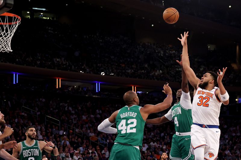 NEW YORK, NEW YORK - MAY 10: Karl-Anthony Towns #32 of the New York Knicks shoots the ball against Al Horford #42 and Jrue Holiday #4 of the Boston Celtics during the second quarter in Game Three of the Eastern Conference Second Round NBA Playoffs at Madison Square Garden on May 10, 2025 in New York City. NOTE TO USER: User expressly acknowledges and agrees that, by downloading and or using this photograph, User is consenting to the terms and conditions of the Getty Images License Agreement. (Photo by Al Bello/Getty Images)