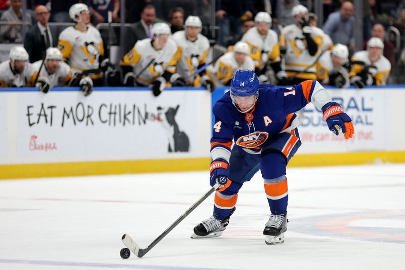 Feb 3, 2026; Elmont, New York, USA; New York Islanders center Bo Horvat (14) brings the puck up ice against against the Pittsburgh Penguins during overtime at UBS Arena. Mandatory Credit: Brad Penner-Imagn Images