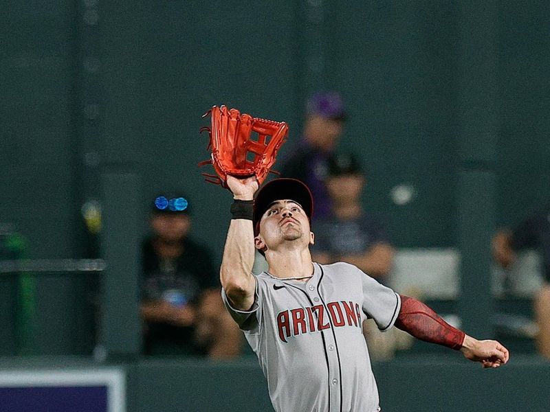Aug 14, 2025; Denver, Colorado, USA; Arizona Diamondbacks right fielder Corbin Carroll (7) makes a catch in the fifth inning against the Colorado Rockies at Coors Field. Mandatory Credit: Isaiah J. Downing-Imagn Images