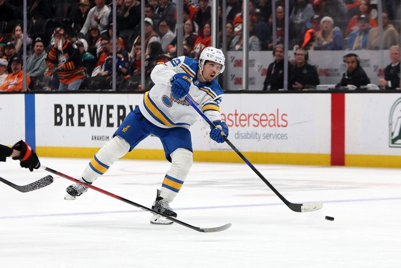 Mar 8, 2026; Anaheim, California, USA;  St. Louis Blues center Pius Suter (22) scores an empty net goal during the third period against the Anaheim Ducks at Honda Center. Mandatory Credit: Kiyoshi Mio-Imagn Images