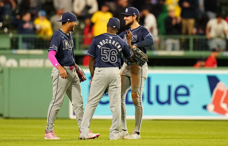 May 13, 2024; Boston, Massachusetts, USA; Tampa Bay Rays center fielder Jose Siri (22), left fielder Randy Arozarena (56) and right fielder Josh Lowe (15) react after defeating the Boston Red Sox in nine innings at Fenway Park. Mandatory Credit: David Butler II-USA TODAY Sports