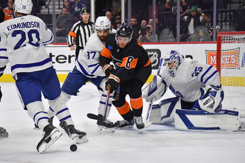 Mar 19, 2024; Philadelphia, Pennsylvania, USA; Toronto Maple Leafs defenseman Timothy Liljegren (37) and Philadelphia Flyers defenseman Cam York (8) battle for the rebound in front of goaltender Ilya Samsonov (35) during the first period at Wells Fargo Center. Mandatory Credit: Eric Hartline-USA TODAY Sports