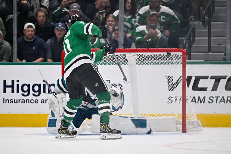 Oct 15, 2024; Dallas, Texas, USA; Dallas Stars left wing Jason Robertson (21) scores a goal against San Jose Sharks goaltender Mackenzie Blackwood (29) during the overtime shootout period at the American Airlines Center. Mandatory Credit: Jerome Miron-Imagn Images