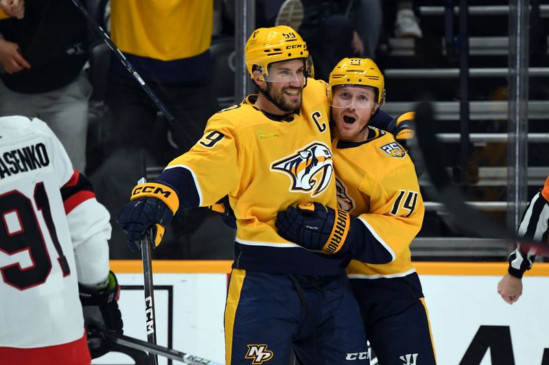 Feb 27, 2024; Nashville, Tennessee, USA; Nashville Predators center Gustav Nyquist (14) celebrates with defenseman Roman Josi (59) after a goal during the third period against the Ottawa Senators at Bridgestone Arena. Mandatory Credit: Christopher Hanewinckel-USA TODAY Sports