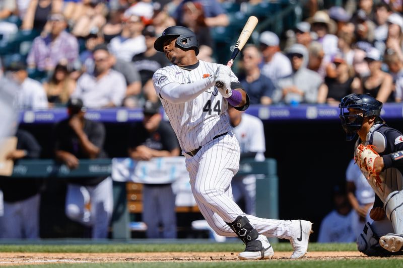 May 27, 2024; Denver, Colorado, USA; Colorado Rockies first baseman Elehuris Montero (44) hits a two RBI single in the fourth inning against the Cleveland Guardians at Coors Field. Mandatory Credit: Isaiah J. Downing-USA TODAY Sports