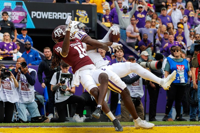 Nov 25, 2023; Baton Rouge, Louisiana, USA;  LSU Tigers wide receiver Brian Thomas Jr. (11) catches a touchdown against Texas A&M Aggies defensive back Sam McCall (16) during the second half at Tiger Stadium. Mandatory Credit: Stephen Lew-USA TODAY Sports