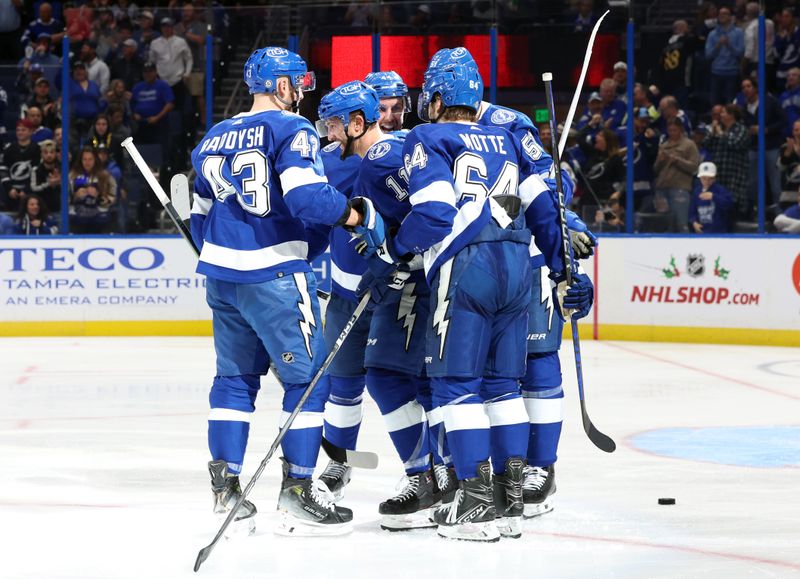 Dec 4, 2023; Tampa, Florida, USA; Tampa Bay Lightning center Luke Glendening (11) is congratulated after he scored a goal against the Dallas Stars  during the third period at Amalie Arena. Mandatory Credit: Kim Klement Neitzel-USA TODAY Sports