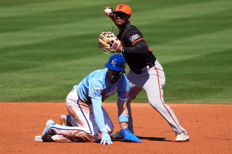 Mar 11, 2024; Surprise, Arizona, USA; Kansas City Royals shortstop Bobby Witt Jr. (7) beats a force out throw to San Francisco Giants second baseman Otto Lopez (54) during the first inning at Surprise Stadium. Mandatory Credit: Joe Camporeale-USA TODAY Sports