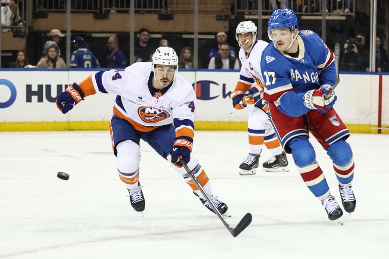 Nov 8, 2025; New York, New York, USA;  New York Islanders center Jean-Gabriel Pageau (44) and New York Rangers defenseman Will Borgen (17) chase after the puck in the second period at Madison Square Garden. Mandatory Credit: Wendell Cruz-Imagn Images