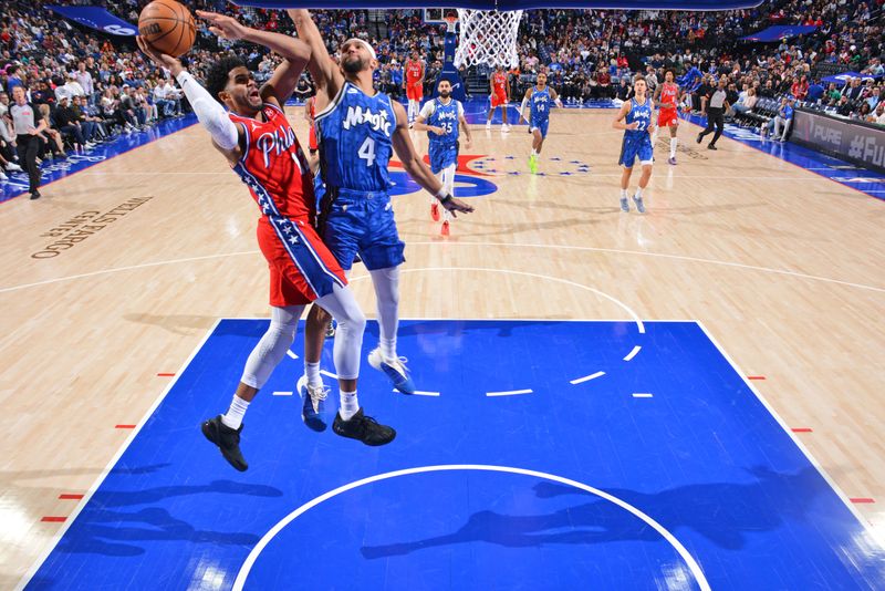 PHILADELPHIA, PA - APRIL 12: Tobias Harris #12 of the Philadelphia 76ers drives to the basket during the game against the Orlando Magic on April 12, 2024 at the Wells Fargo Center in Philadelphia, Pennsylvania NOTE TO USER: User expressly acknowledges and agrees that, by downloading and/or using this Photograph, user is consenting to the terms and conditions of the Getty Images License Agreement. Mandatory Copyright Notice: Copyright 2024 NBAE (Photo by Jesse D. Garrabrant/NBAE via Getty Images)