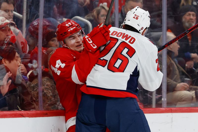Jan 29, 2026; Detroit, Michigan, USA;  Washington Capitals center Nic Dowd (26) checks Detroit Red Wings defenseman Axel Sandin-Pellikka (44) in the first period at Little Caesars Arena. Mandatory Credit: Rick Osentoski-Imagn Images