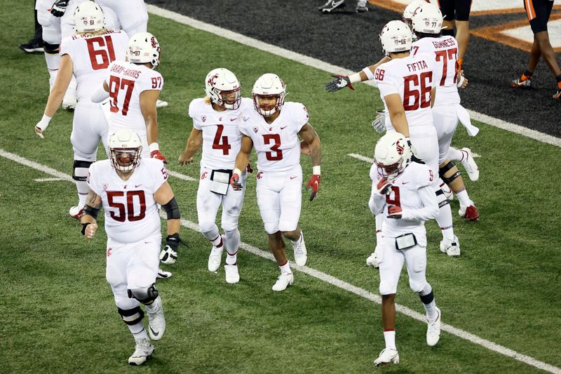 Nov 7, 2020; Corvallis, Oregon, USA; Washington State Cougars running back Deon McIntosh (3) is congratulated by quarterback Jayden de Laura (4) after scoring a touchdown against the Oregon State Beavers during the first half at Reser Stadium. Mandatory Credit: Soobum Im-USA TODAY Sports